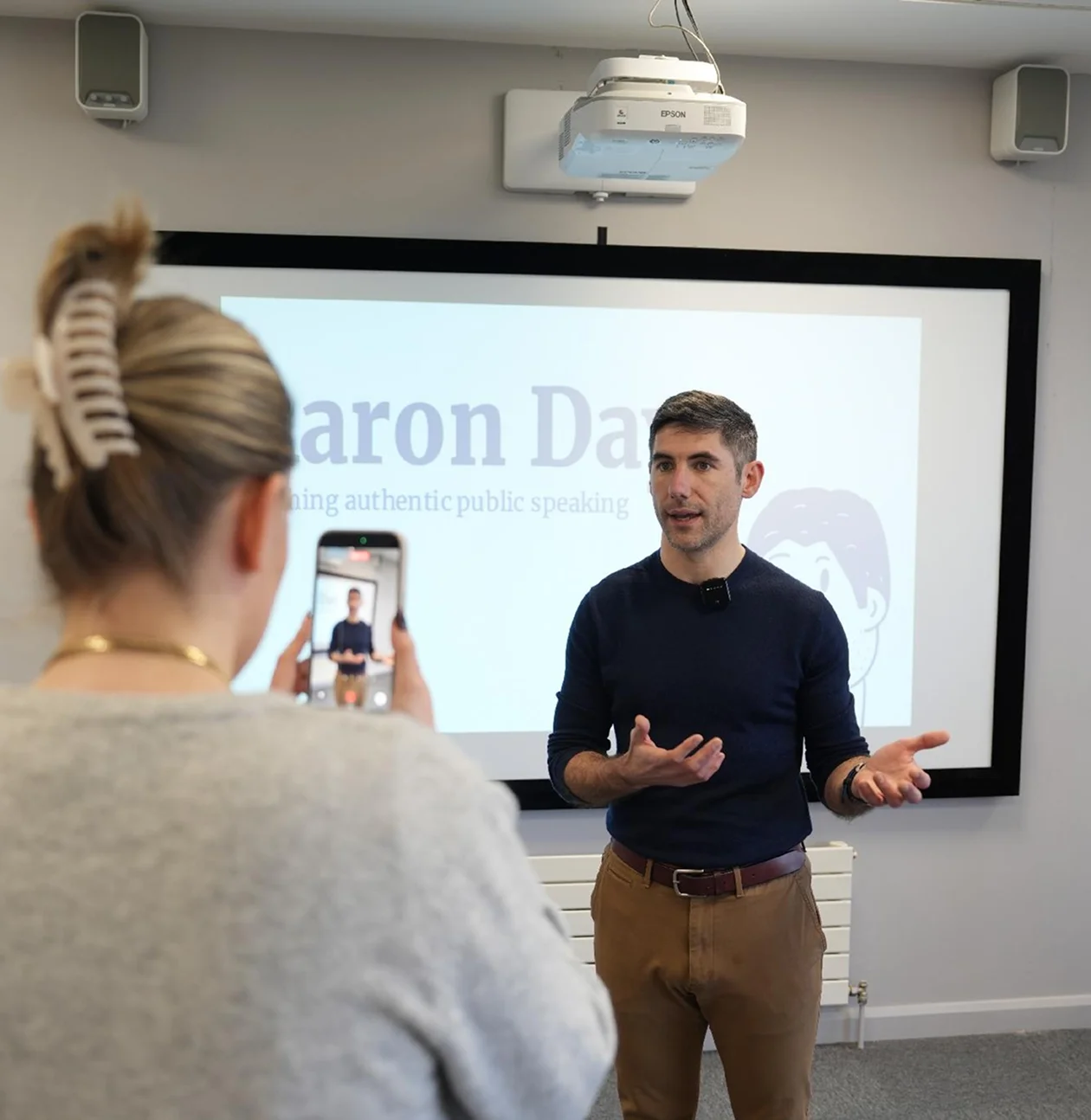 Aaron giving presentation, filmed by audience member.
